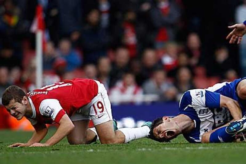 Jack Wilshere, left, was given a red card for a mistimed tackle on Nikola Zigic.