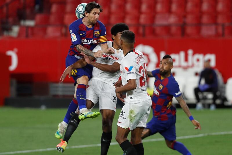 Lionel Messi leaps for a header at the Ramon Sanchez-Pizjuan stadium in Seville. AP