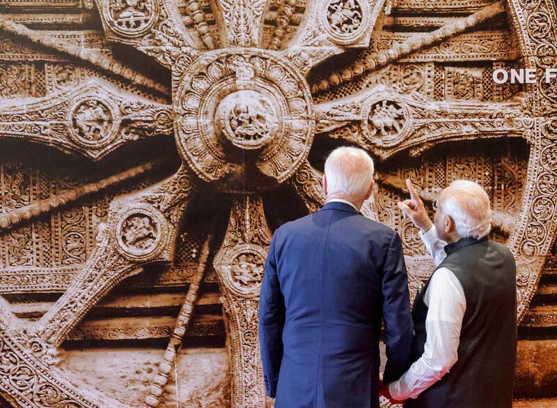 Indian Prime Minister Narendra Modi (right) and US President Joe Biden look at a mural of the Konark Sun temple wheel during the G20 summit in New Delhi on Saturday. AFP