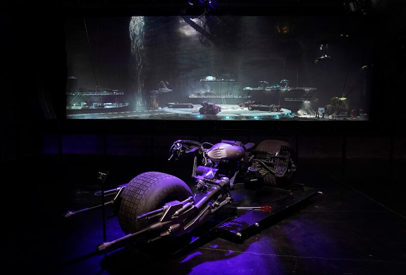 A 3D rendering of the The Batcave stands behind the Batpod from the 2008 film 'The Dark Knight' in the Action and Magic Made Here interactive experience.