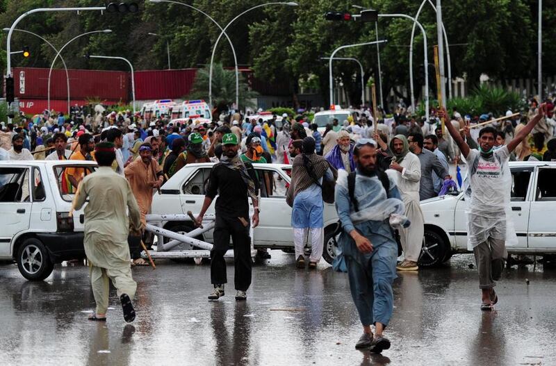 Anti-government protesters armed with rocks and wooden clubs clashed with police in Islamabad September 1, hours after the powerful army called for a peaceful resolution to the political crisis rocking Pakistan. Asif Hassan/AFP Photo