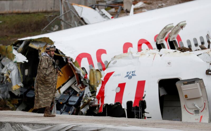 A soldier stands guard near the Pegasus Airlines Boeing 737-86J plane wreckage, after it overran the runway during landing and crashed, at Istanbul's Sabiha Gokcen airport, Turkey. REUTERS