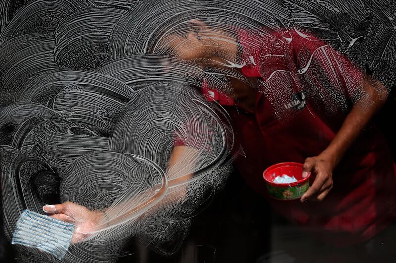 A man cleans the window of a restaurant at Basantapur Durbar Square in Kathmandu, Nepal. AP Photo