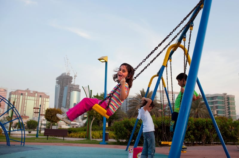 Five-year-old Leen al Khateeb smiles as she's enjoying a swing ride while her siblings play nearby in the Family Park in the Khalidiya neighborhood in Abu Dhabi on Sunday evening, July 31, 2011, the last day before the start of the Ramadan. (Silvia Razgova/The National)