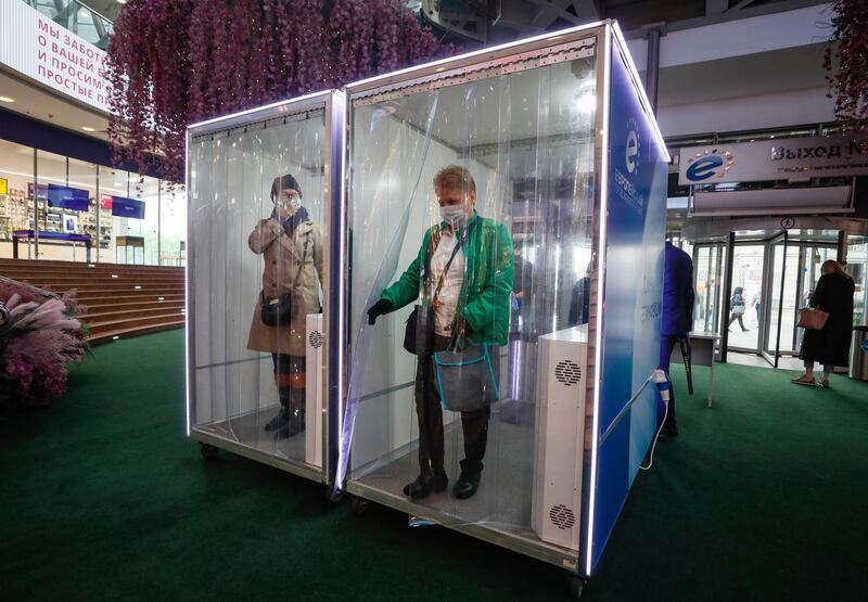 Customers walk through a disinfection cabin at entrance of the Evropeyskiy shopping Ñenter in Moscow, Russia.  EPA