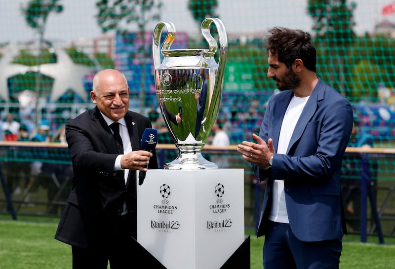 Turkish Football Federation president Mehmet Buyukeksi and former Turkey footballer Hamit Altintop unveil the trophy. Reuters