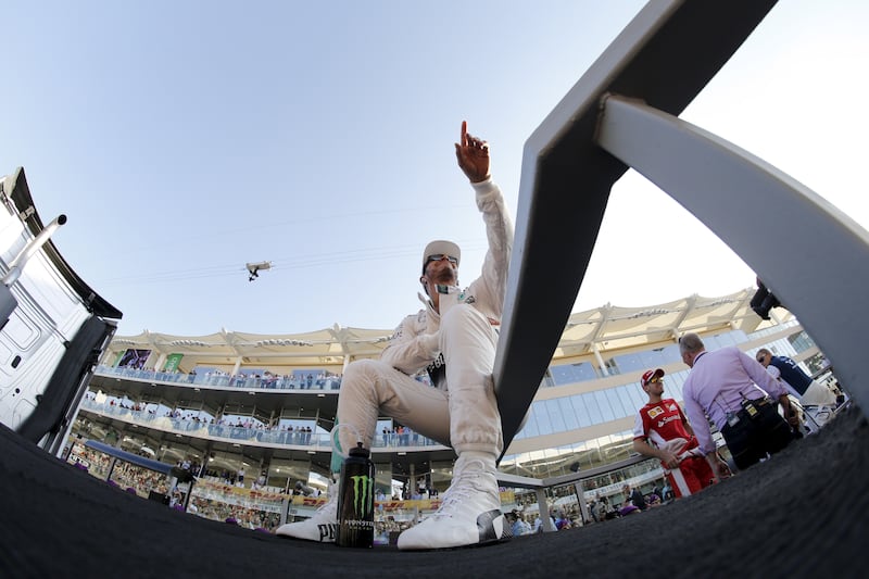 Hamilton gestures to fans during the drivers' parade before the 2015 Abu Dhabi Grand Prix at Yas Marina Circuit. Reuters