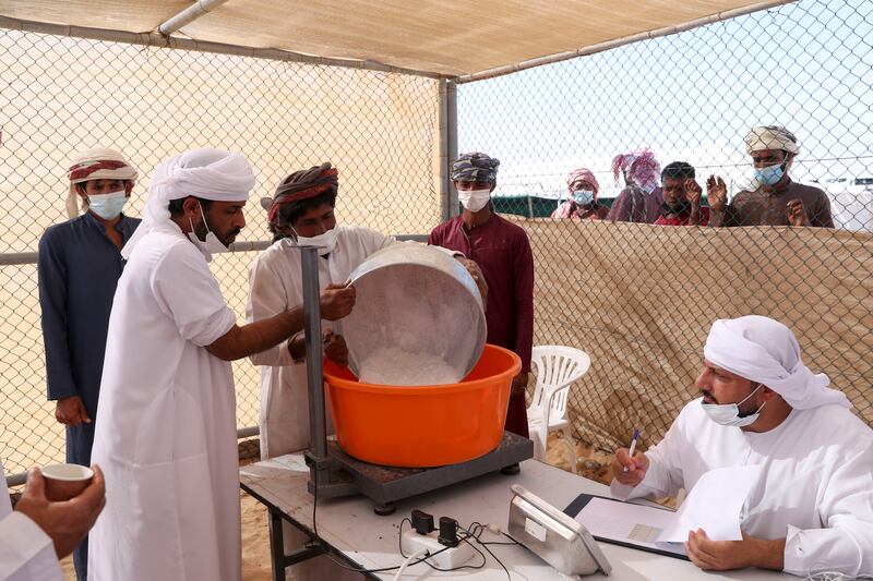 An amount of milk collected is measured as part of the milking camel contest.
