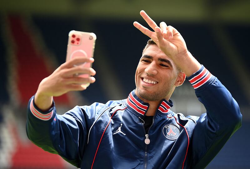 Paris Saint-Germain's Moroccan defender Achraf Hakimi takes a selfie at the Parc des Princes stadium.