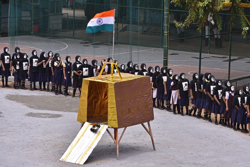 Students in Chennai form a circle around a rudimentary replica of the Chandrayaan-3 lander before its attempt to land on the Moon. EPA