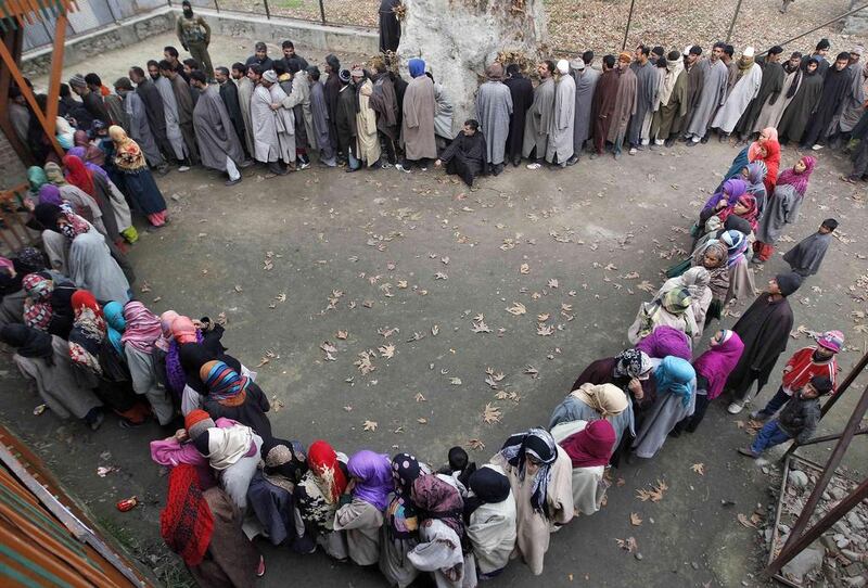 Kashmiri people wait in queues outside a polling station to cast their votes during the fourth phase of the state assembly election in Srinagar, India. Danish Ismail / Reuters