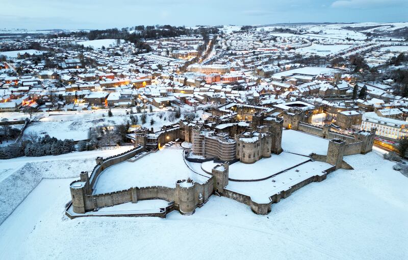 Snow-covered fields surround Alnwick Castle in Northumberland. PA