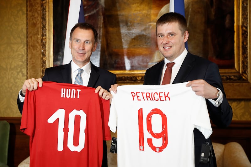 Mr Hunt and his Czech counterpart Tomas Petricek hold up football shirts on arrival at the Foreign Office in London in March 2019. Getty