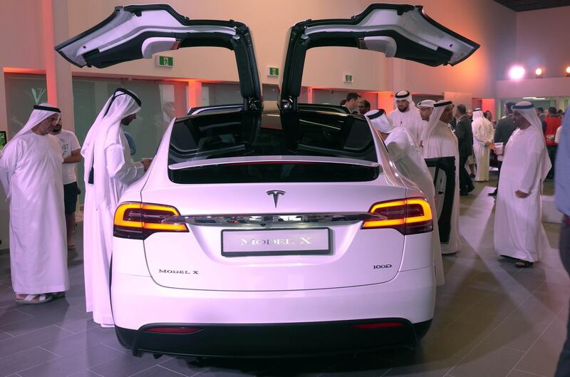 Visitors to the Tesla showroom examine the Tesla Model X. New green auto loans will help to catapult sales of zero-carbon emission vehicles, as part of the UAE’s clean ­energy drive. James Langton / The National