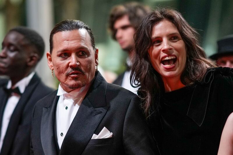 Johnny Depp, left, and director Maiwenn pose for photographers following Jeanne du Barry film premiere. AP