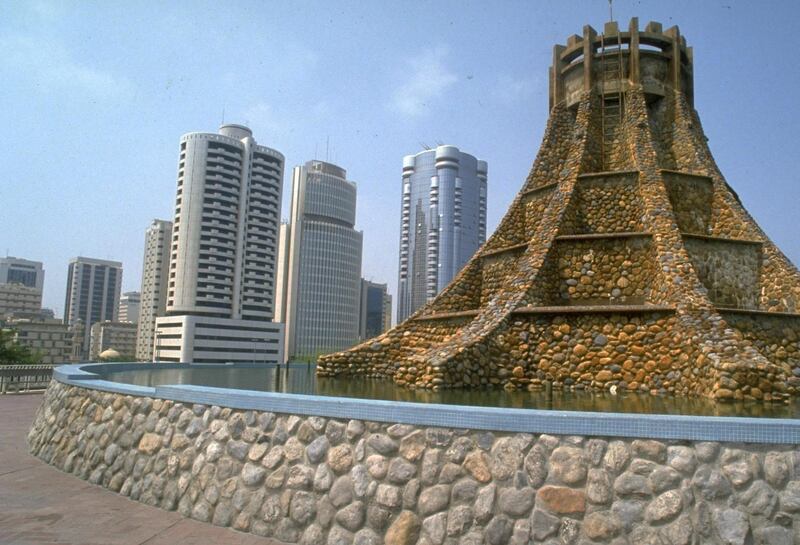 Elaborate stone fountain, w. castle turret-like shape gracing corniche area, w. office towers looming beyond.  (Photo by Barry Iverson/The LIFE Images Collection via Getty Images/Getty Images)