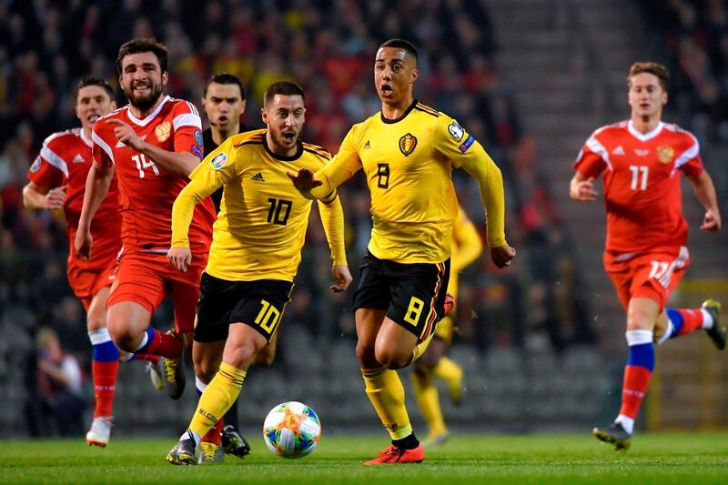 Belgium's Eden Hazard, left, and Youri Tielemans, right, run after the ball. AFP