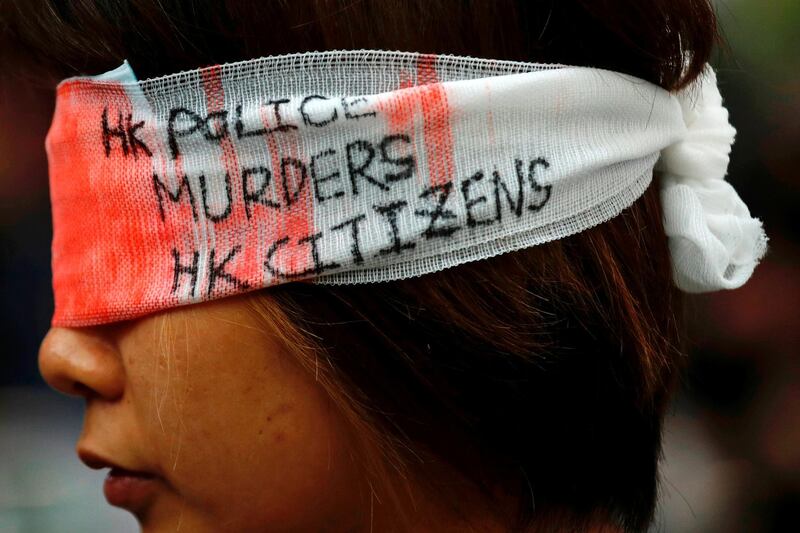 An anti-extradition bill protester covers her eye with a gauze during a mass demonstration after a woman was shot in the eye during a protest at Hong Kong International Airport, in Hong Kong, China. Reuters