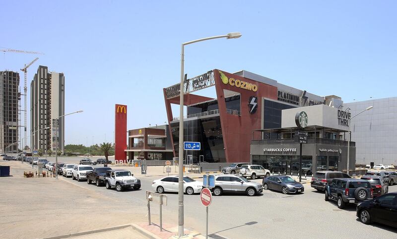 Vehicles queue in front of a drive-through fast food restaurant in Kuwait City.   AFP