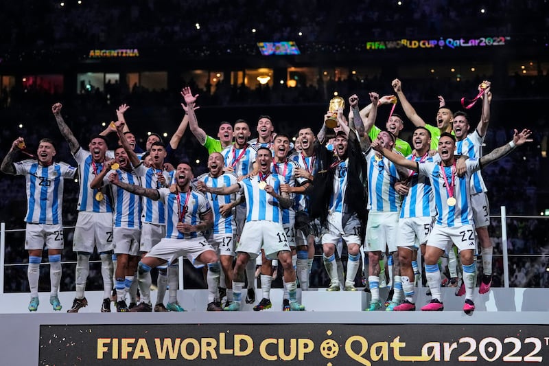 Lionel Messi holds up the trophy after Argentina defeated France on penalties in the World Cup final at Lusail Stadium in Qatar, on Sunday, December 18, 2022.  AP