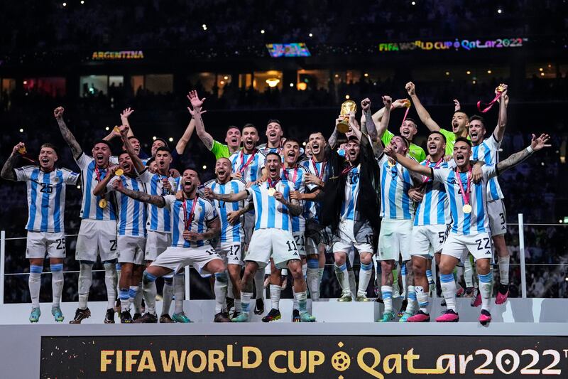 Lionel Messi holds up the trophy after Argentina defeated France on penalties in the World Cup final at Lusail Stadium in Qatar, on Sunday, December 18, 2022.  AP