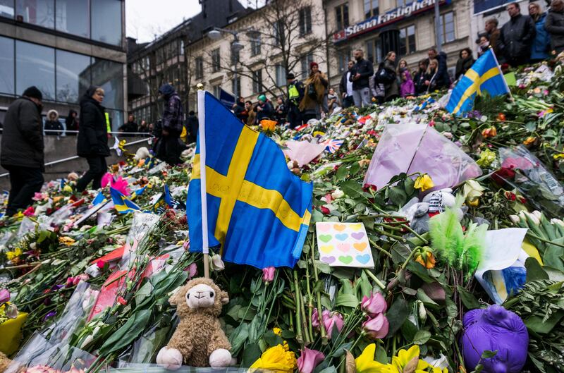 A makeshift memorial commemorates the victims of a terror attack near the site where a lorry drove pedestrians near the Ahlens department store in Stockholm, Sweden on April 7, 2014, killing four people and injuring 15. Jonathan Nackstrand / AFP / April 14, 2017