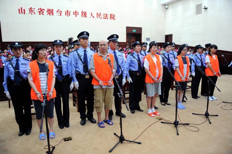 Five cult members Zhang Fan, Zhang Lidong, Lyu Yingchun, Zhang Hang and Zhang Qiaolian stand trial on murder charges in Yantai Intermediate People's Court in Yantai City, east China's Shandong Province on August 21, 2014. A woman was beaten to death on May 28 at a McDonald's outlet in Zhaoyuan City, Yantai, after she refused to give her telephone number to the suspects, who were allegedly trying to recruit new members for their organisation. Courtesy Xinhua Press