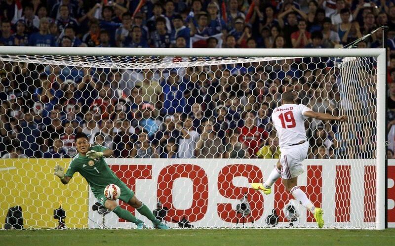 UAE's Ismail Ahmed shoots and scores the winning penalty against Japan on Friday to send the Emiratis to the Asian Cup semi-finals on Friday. Jason Reed / Reuters