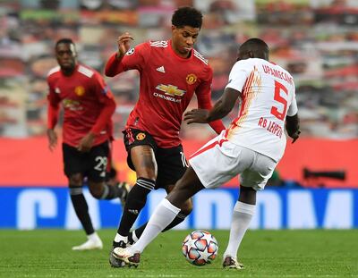 Manchester United's English striker Marcus Rashford (C) vies with RB Leipzig's French defender Dayot Upamecano during the UEFA Champions league group H football match between Manchester United and RB Leipzig at Old Trafford stadium in Manchester, north west England, on October 28, 2020. Manchester United won the match 5-0. / AFP / Anthony Devlin
