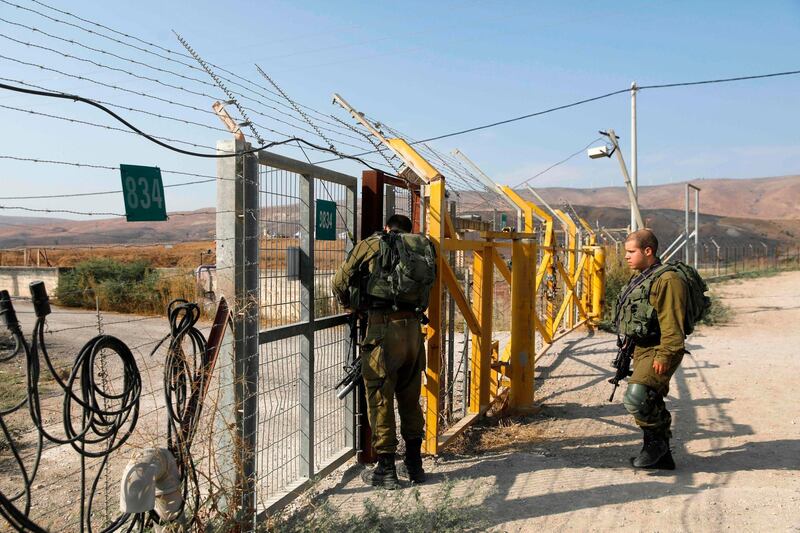 Israeli soldiers close a border gate on the Israeli side of the border at the Jordan Valley site of Naharayim, also known as Baqura in Jordan, east of the Jordan river. The villages of Baqoura and Al Ghamr, which were annexed to Israel under the 1994 peace treaty, had officially returned to Jordan. AFP