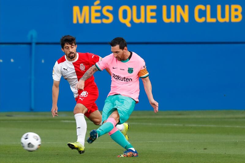 Barcelona attacker Lionel Messi, right, under pressure from Girona's Jairo Izquierdo during their pre-season friendly at the Johan Cruyff Stadium. Barca won the match 3-1. AP