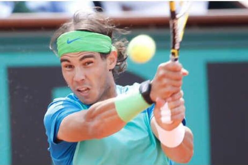 Rafael Nadal of Spain returns a ball to Robin Soderling of Sweden.