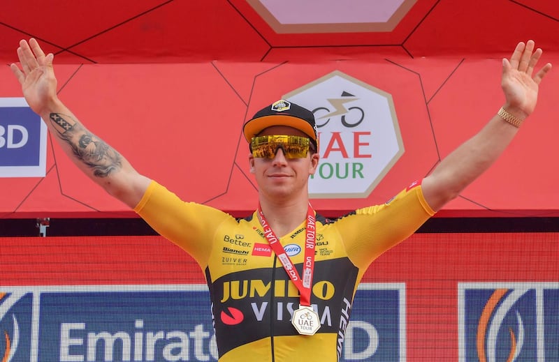 Jumbo Visma rider Dylan Groenewegen of The Netherlands celebrates on the podium after winning Stage 4 of the UAE cycling tour in Dubai, on February 26, 2020. / AFP / Giuseppe CACACE
