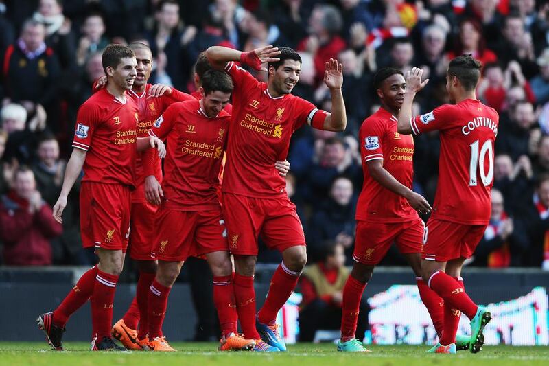 Liverpool’s Luis Suarez, centre, hopes he can translate his scoring frenzy into a title. Clive Brunskill / Getty Images

