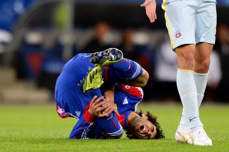 Basel's Egyptian midfielder Mohamed Salah reacts in pain during an UEFA Champions League football match between FC Basel and Steaua Bucharest, in Basel. Fabrice Coffrini / AFP