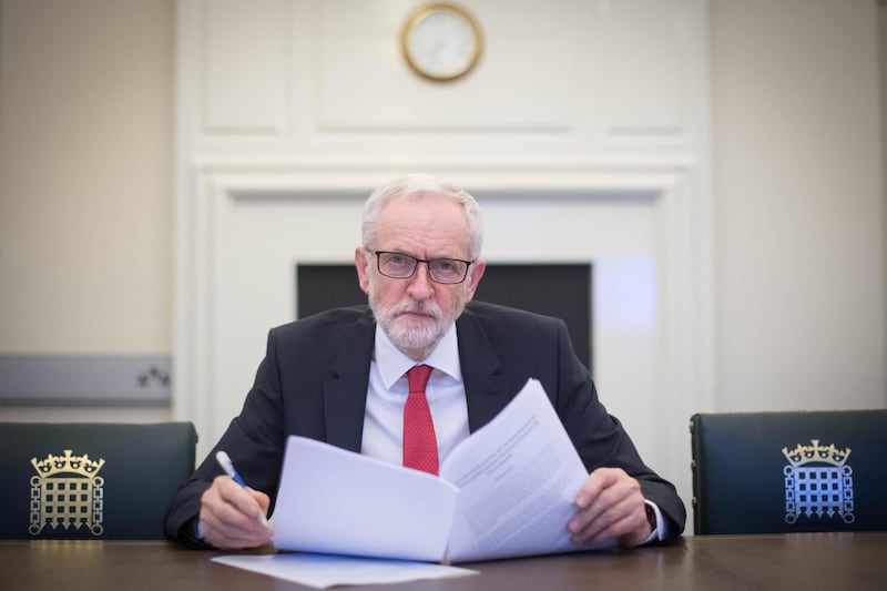TOPSHOT - Britain's main opposition Labour Party leader Jeremy Corbyn poses with a copy of the Political Declaration setting out the framework for the future UK-EU relationship, in his office in the Houses of Parliament in London on April 2, 2019.  Prime Minister Theresa May said Tuesday she would ask the EU to delay Brexit again to avoid Britain crashing out of the bloc next week, signalling she could accept a closer relationship with Europe to break months of political deadlock. In a move which enraged the Brexit-supporting wing of her Conservative Party, she also offered to work with Labour main opposition leader Jeremy Corbyn, who favours closer ties with the European Union. Corbyn responded saying he was "very happy" to meet. / AFP / POOL / Stefan Rousseau
