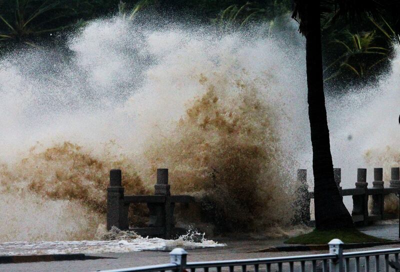 A wave caused by Typhoon Hato surges past the barrier along the seacoast in Zhuhai in China's southern Guangzhou province. AFP.