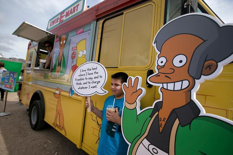 FILE - In this March 15, 2015 file photo, Migael Pimentel, 9, holds up an Apu saying as he has his photo taken at the Simpsons Kwik-E-Mart Truck at South Bites Food during SXSW at the Austin Convention Center in Austin, Texas. "The Simpsons" briefly addressed Sunday, April 8, 2018, criticism of its portrayal of its Indian shop owner, Apu. But a comedian who helped spark a conversation about the character calls the show's response "sad" and attacked the show on Twitter for reducing a discussion about racism to political correctness. (Deborah Cannon/Austin American-Statesman via AP, File)