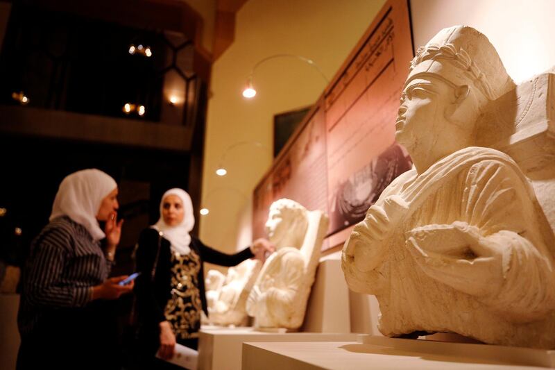 Visitors look at restored sculptures in an exhibition, at the Opera house in Damascus, Syria. Reuters