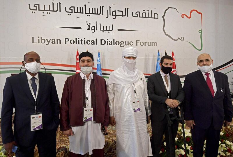 Libyan delegates, including (L-R) Abdessalam Shuha, Abdallah Shibani, Hussein Mohamed Elansari, an unidentified participant and Abdel Majid Mlayqtah attend the opening of the Libyan Political Dialogue Forum hosted in Gammarth on the outskirts of Tunisia's capital, on November 9, 2020.  / AFP / FETHI BELAID
