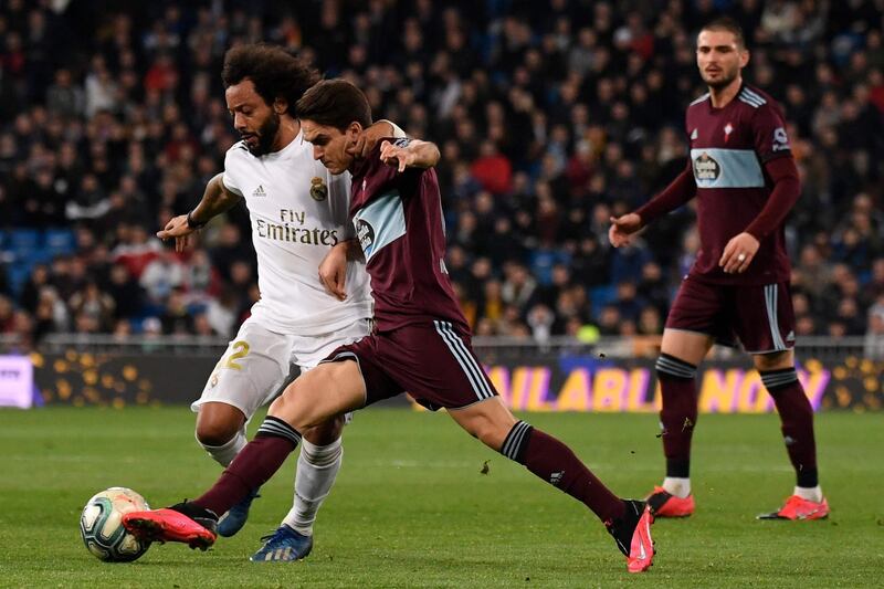 Real Madrid's Brazilian defender Marcelo challenges Celta Vigo's Spanish midfielder Denis Suarez. AFP