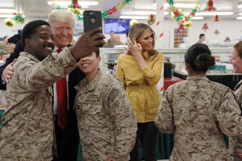 US President Donald Trump and first lady Melania Trump greet military personnel at the dining facility during an unannounced visit to Al Asad Air Base, Iraq. Reuters