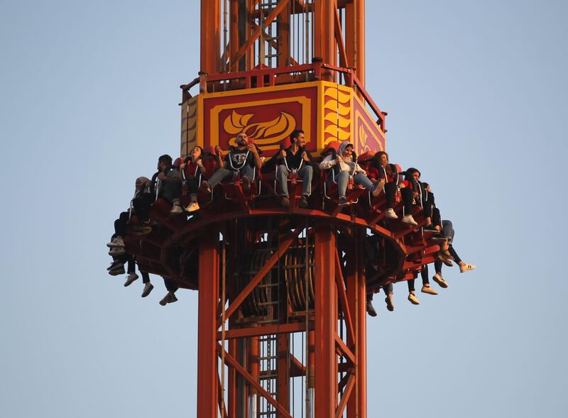 People sit on a ride at the amusement park in Baghdad's Zawraa Park.  AFP