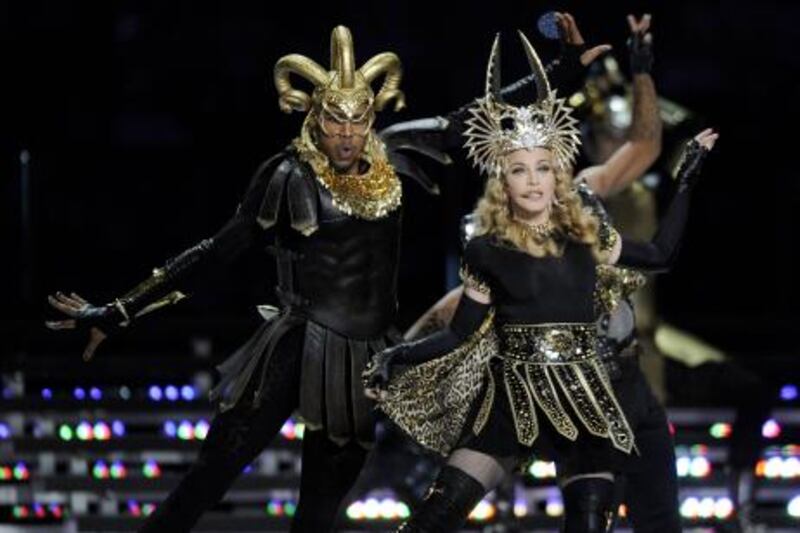 Singer Madonna (R) performs during the NFL Super Bowl XLVI halftime show on February 5, 2012 at Lucas Oil Stadium in Indianapolis, Indiana. AFP PHOTO / TIMOTHY A. CLARY The Giants defeated the Patriots 21-17.  AFP PHOTO / TIMOTHY A. CLARY
 *** Local Caption ***  806585-01-08.jpg