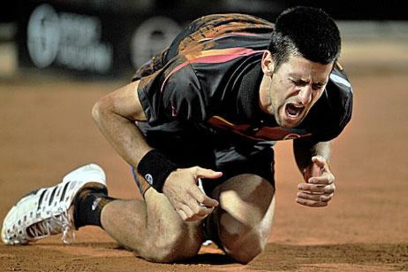 Novak Djokovic falls to the ground as he rejoices his conquest over Andy Murray.