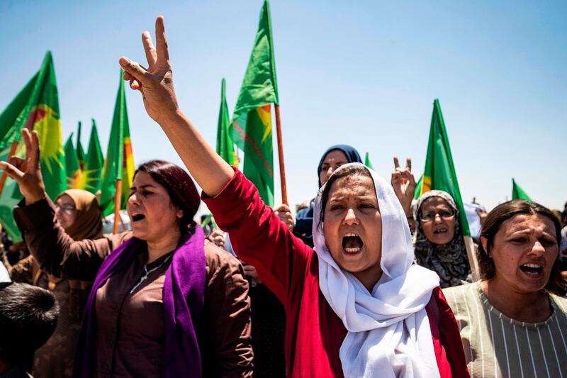 Syrian Kurdish women chant slogans and wave the flag of Kongreya Star, a confederation of women’s organisations in northeastern Syria, during a demonstration in front of a US base in the countryside of the Hasakeh province, to protest Turkish offensives in the northeastern areas of the country. AFP