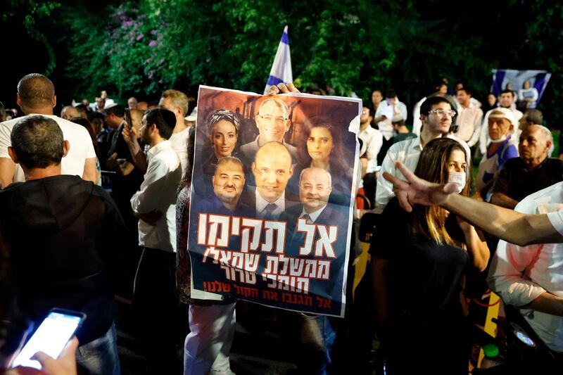 Supporters of Mr Netanyahu rally in Tel Aviv. Israel's opposition leader Yair Lapid says he has succeeded in forming a coalition to end the rule of the country's longest serving leader. AFP