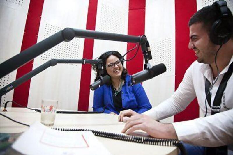 Noof Assi, left, who works for an NGO and presents a late-night radio show, would rather talk about Iraq's future than dwell on the past.