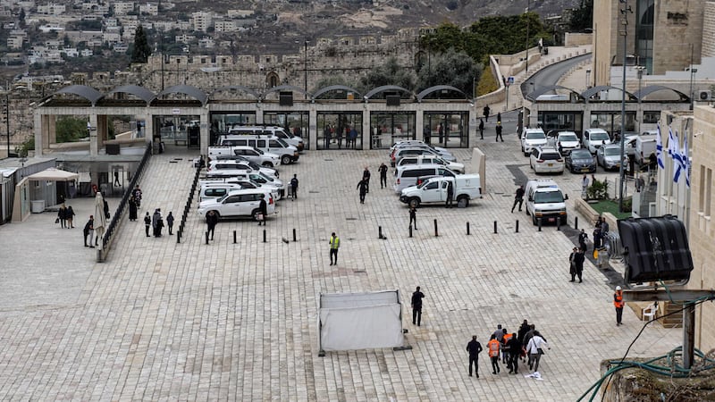 Israeli paramedics carry a victim at the Western Wall plaza away from the scene.