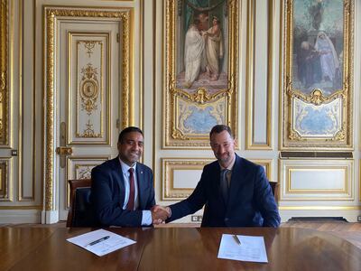 Tejpaul Bhatia, chief revenue officer at Axiom Space and Paul Bate, chief executive of the UK Space Agency, sign a deal for the two organisations to work together. PA